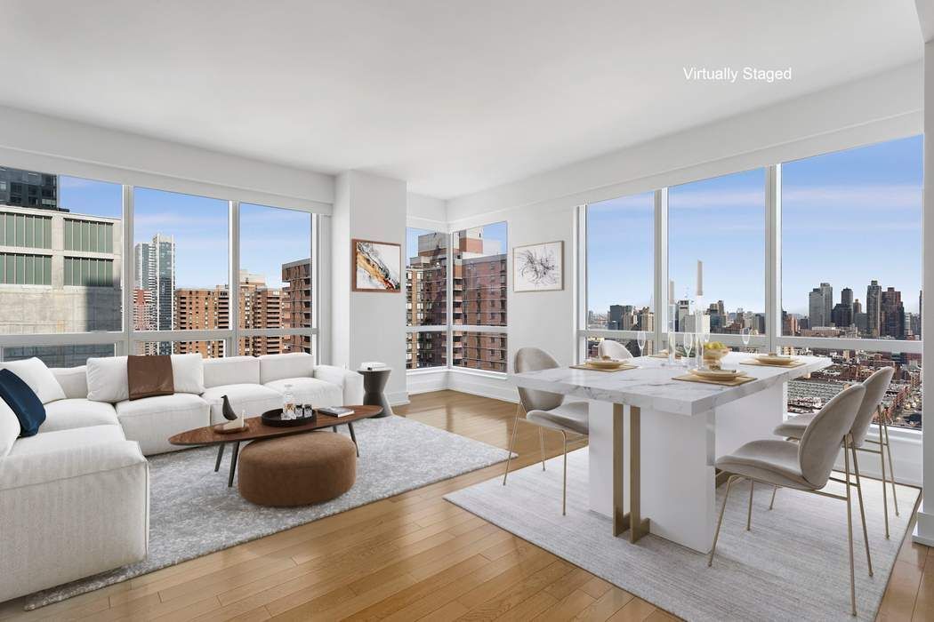350 West 42nd Street, Unit 36B Manhattan, NY 10036 - Photo 1 of 17 a living room with furniture and a large window