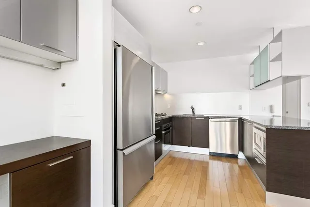 a kitchen with stainless steel appliances a refrigerator and a sink