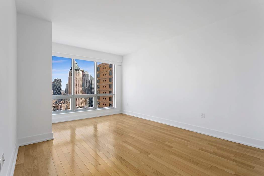 350 West 42nd Street, Unit 36B Manhattan, NY 10036 - Photo 7 of 17 a view of an empty room with a window