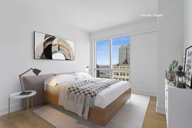 a bedroom with a bed and glass windows