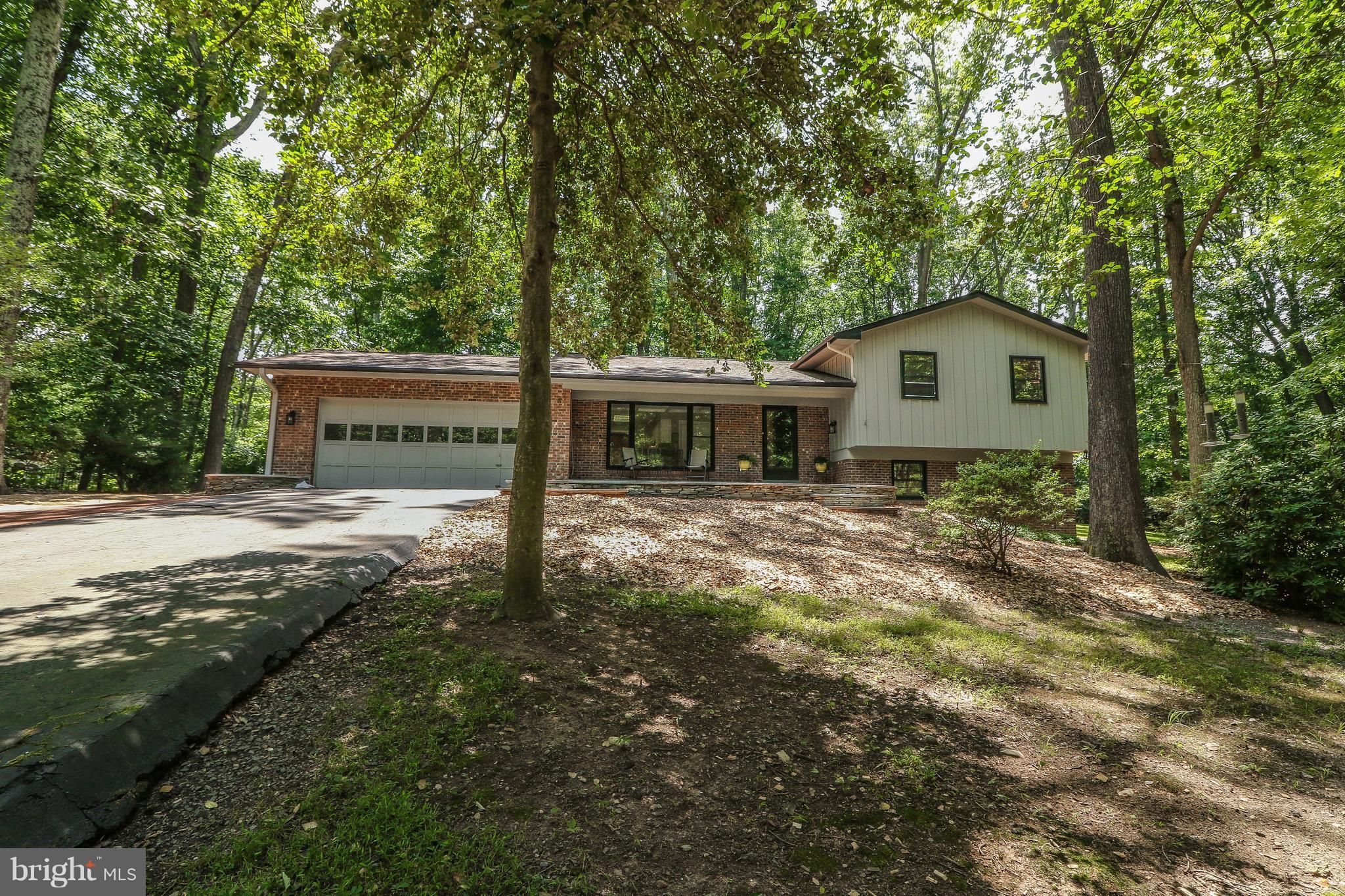 12003 Whip Road Reston, VA 20191 - Photo 1 of 28 a front view of a house with a yard