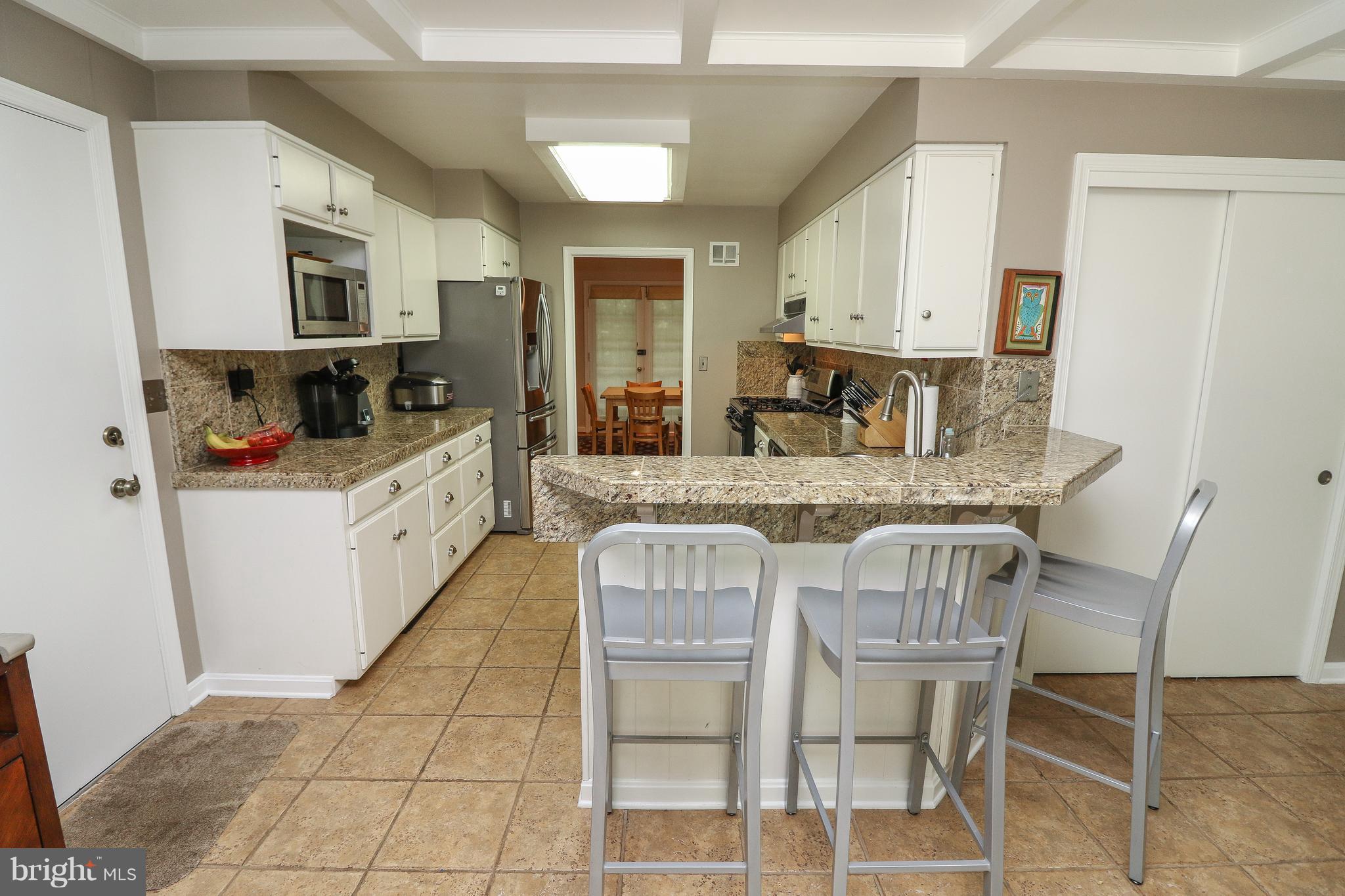 12003 Whip Road Reston, VA 20191 - Photo 6 of 28 a kitchen with granite countertop a stove a sink and a refrigerator