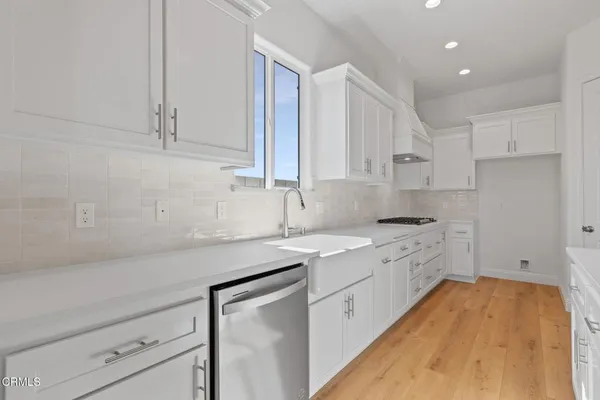 a kitchen with a sink stove and cabinets