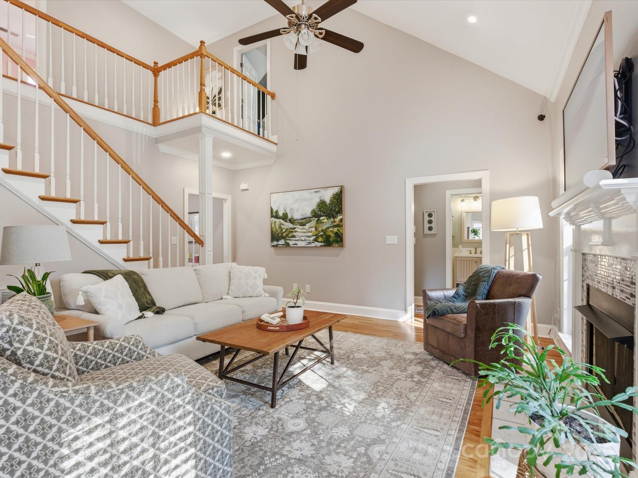 4601 Magnolia Ridge Drive Waxhaw, NC 28173 - Photo 14 of 48 a living room with furniture a fireplace and a chandelier