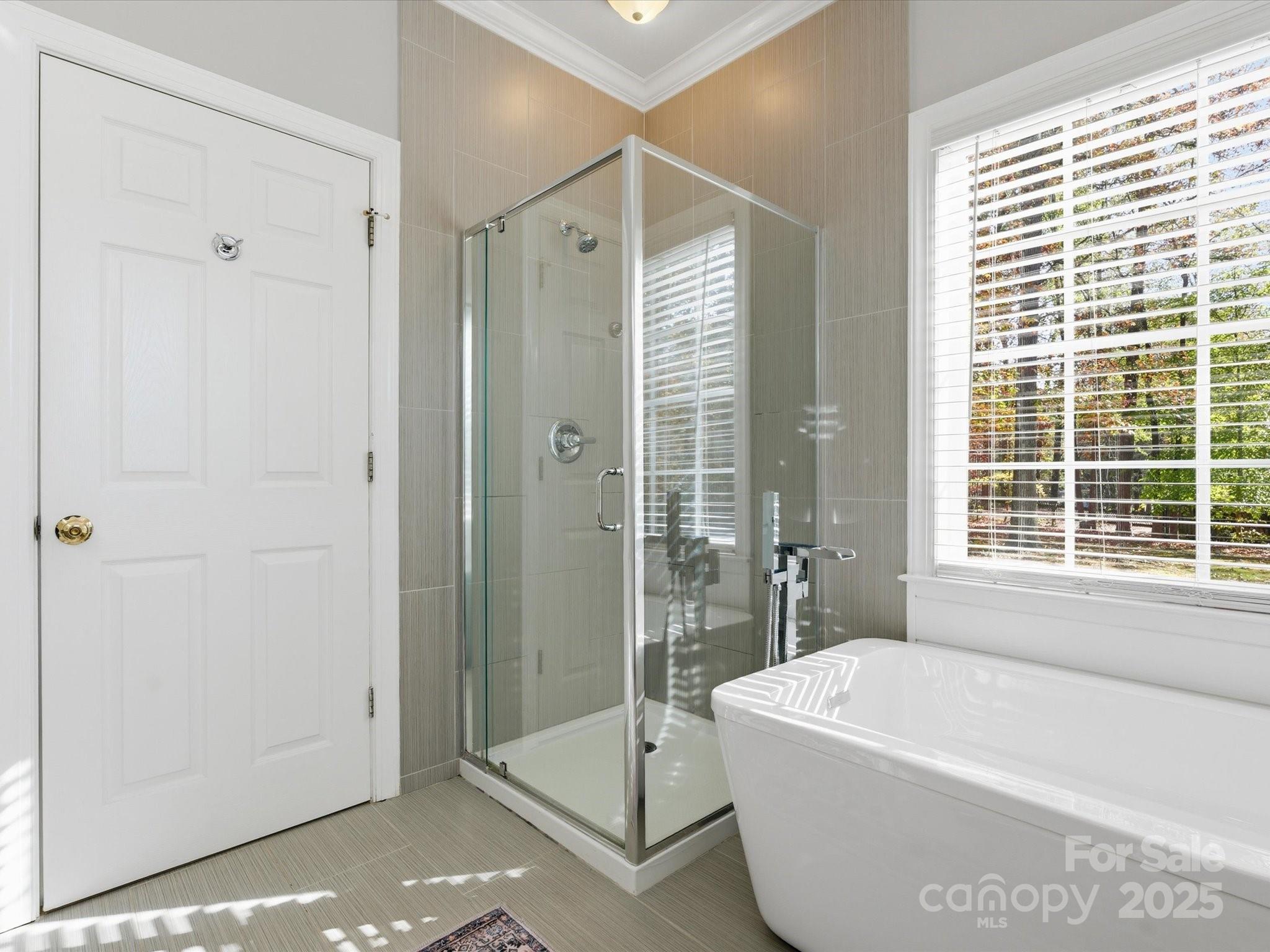 4601 Magnolia Ridge Drive Waxhaw, NC 28173 - Photo 26 of 48 a bathroom with a tub a sink and glass door shower