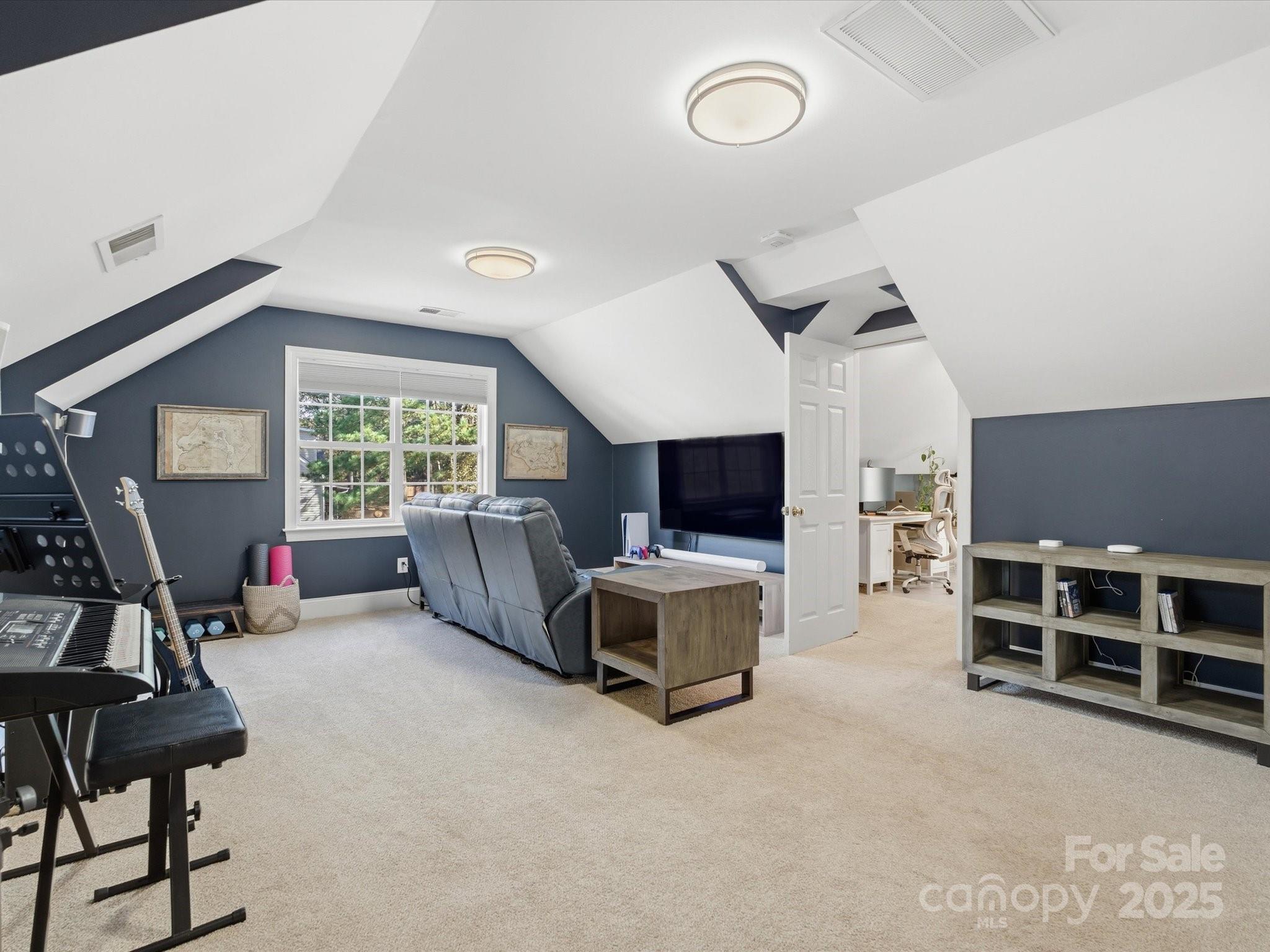 4601 Magnolia Ridge Drive Waxhaw, NC 28173 - Photo 32 of 48 a living room with furniture a flat screen tv and a window