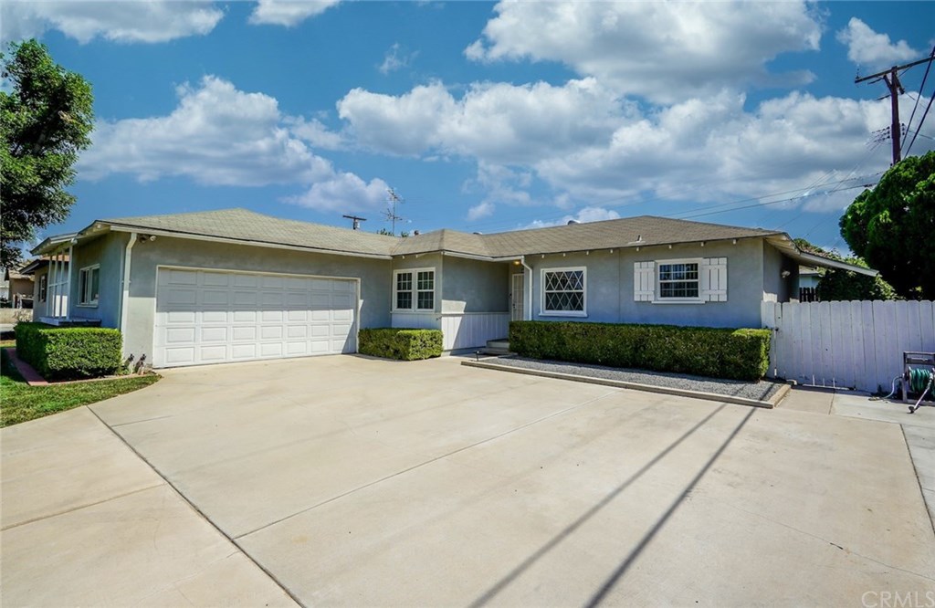 8682 Garfield Street Riverside, CA 92504 - Photo 1 of 1 a front view of a house with a yard and garage