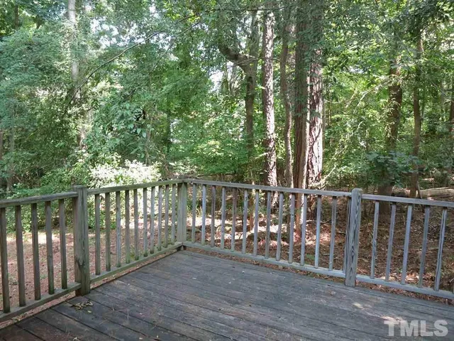 a view of a deck with wooden floor and fence