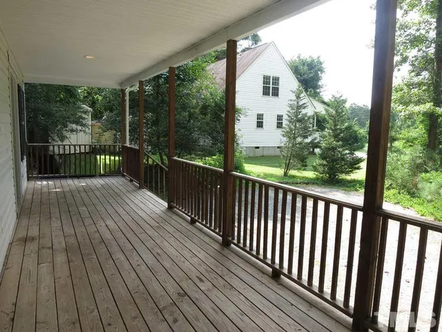 a view of a balcony with wooden floor
