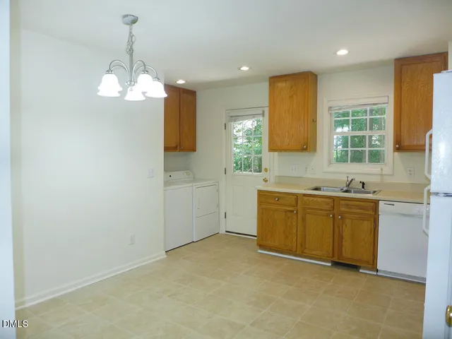 a kitchen with sink cabinets and window