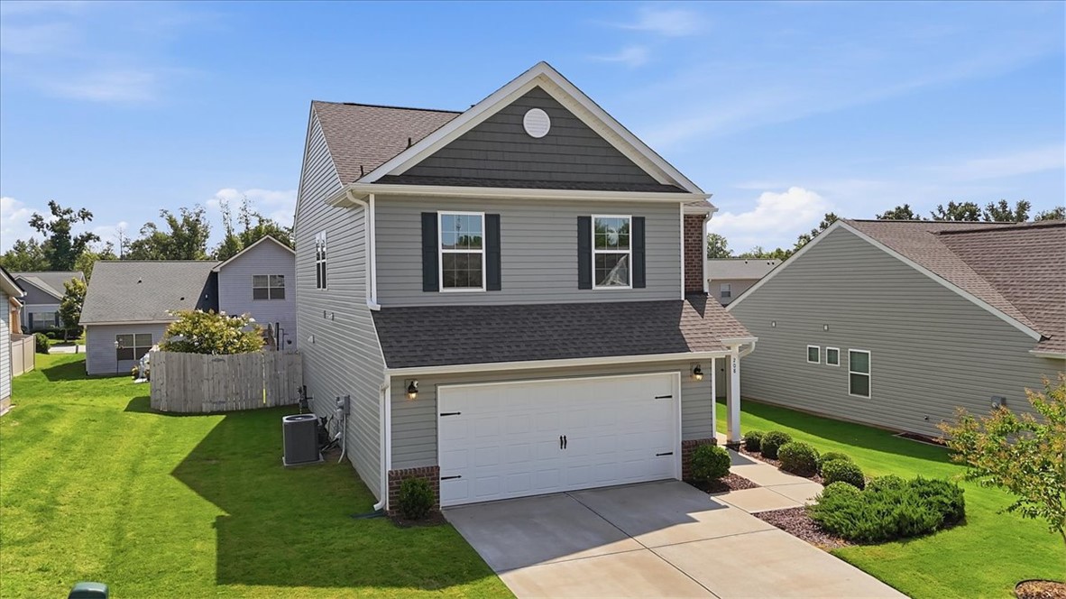 208 Grassy Creek Way Pendleton, SC 29670 - Photo 2 of 43 A well-maintained facade with modern siding and an attached garage offers inviting curb appeal.