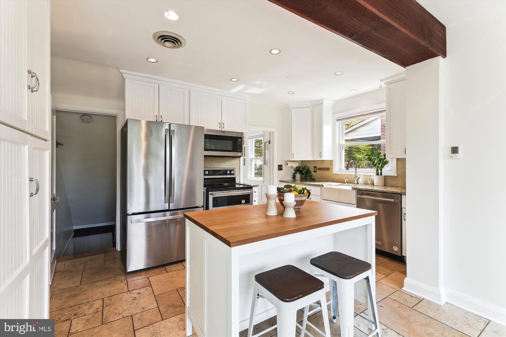 501 Dunkirk Road Baltimore, MD 21212 - Photo 12 of 38 a kitchen with refrigerator and chairs