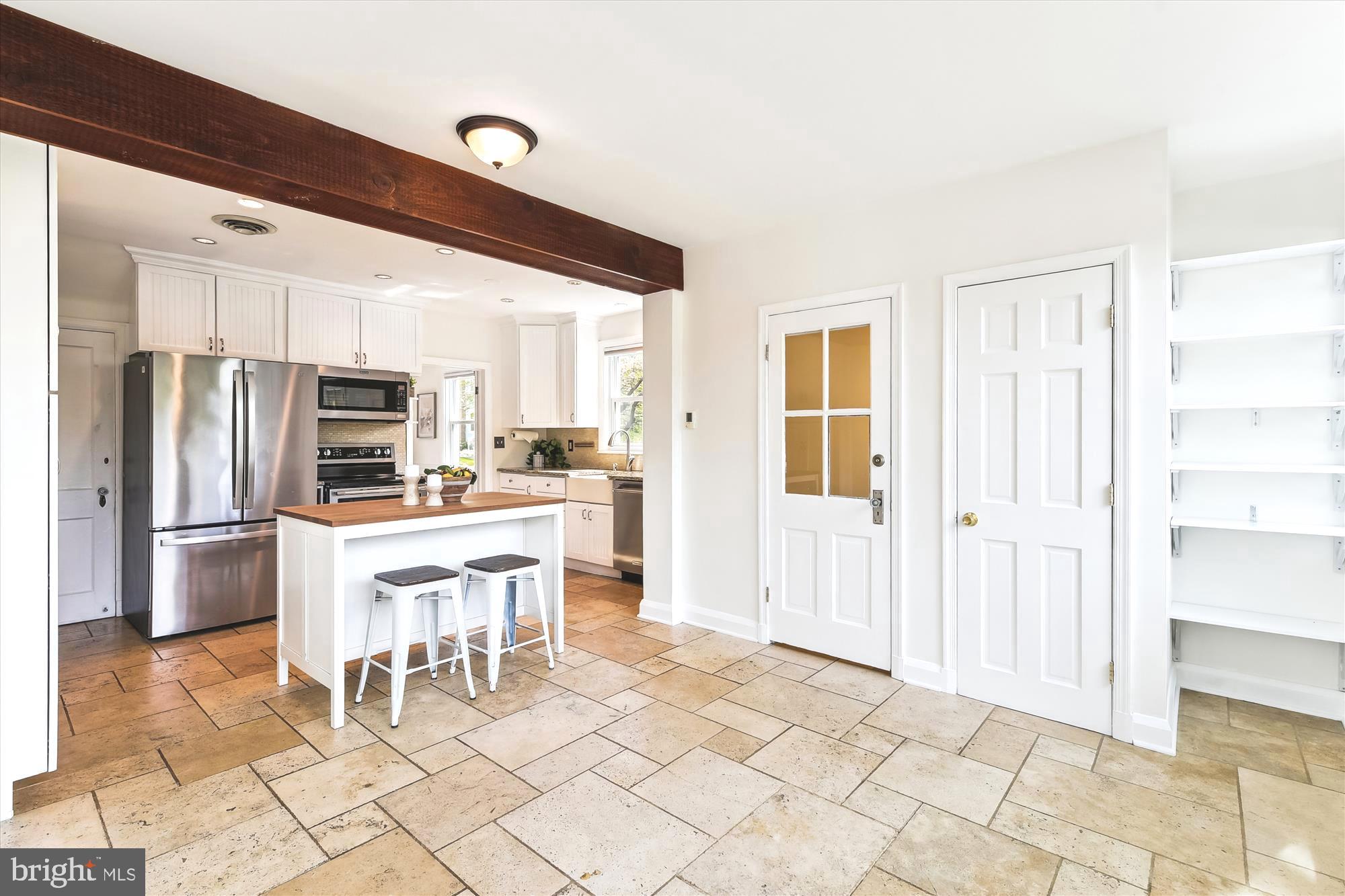501 Dunkirk Road Baltimore, MD 21212 - Photo 13 of 38 a kitchen with stainless steel appliances a refrigerator and a stove top oven