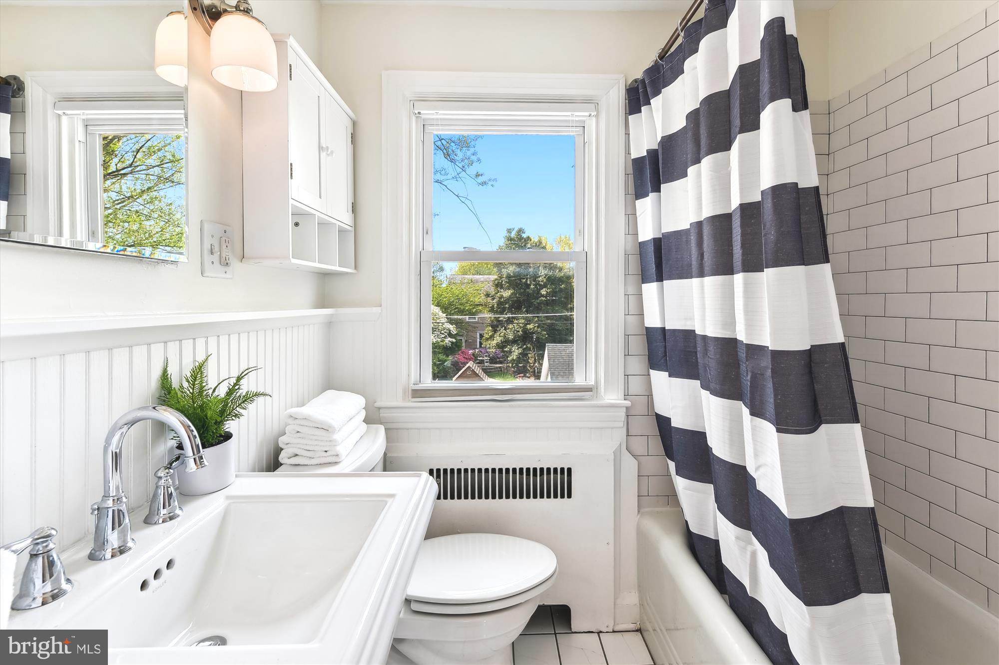 501 Dunkirk Road Baltimore, MD 21212 - Photo 18 of 38 a bathroom with a sink a toilet a window and shower
