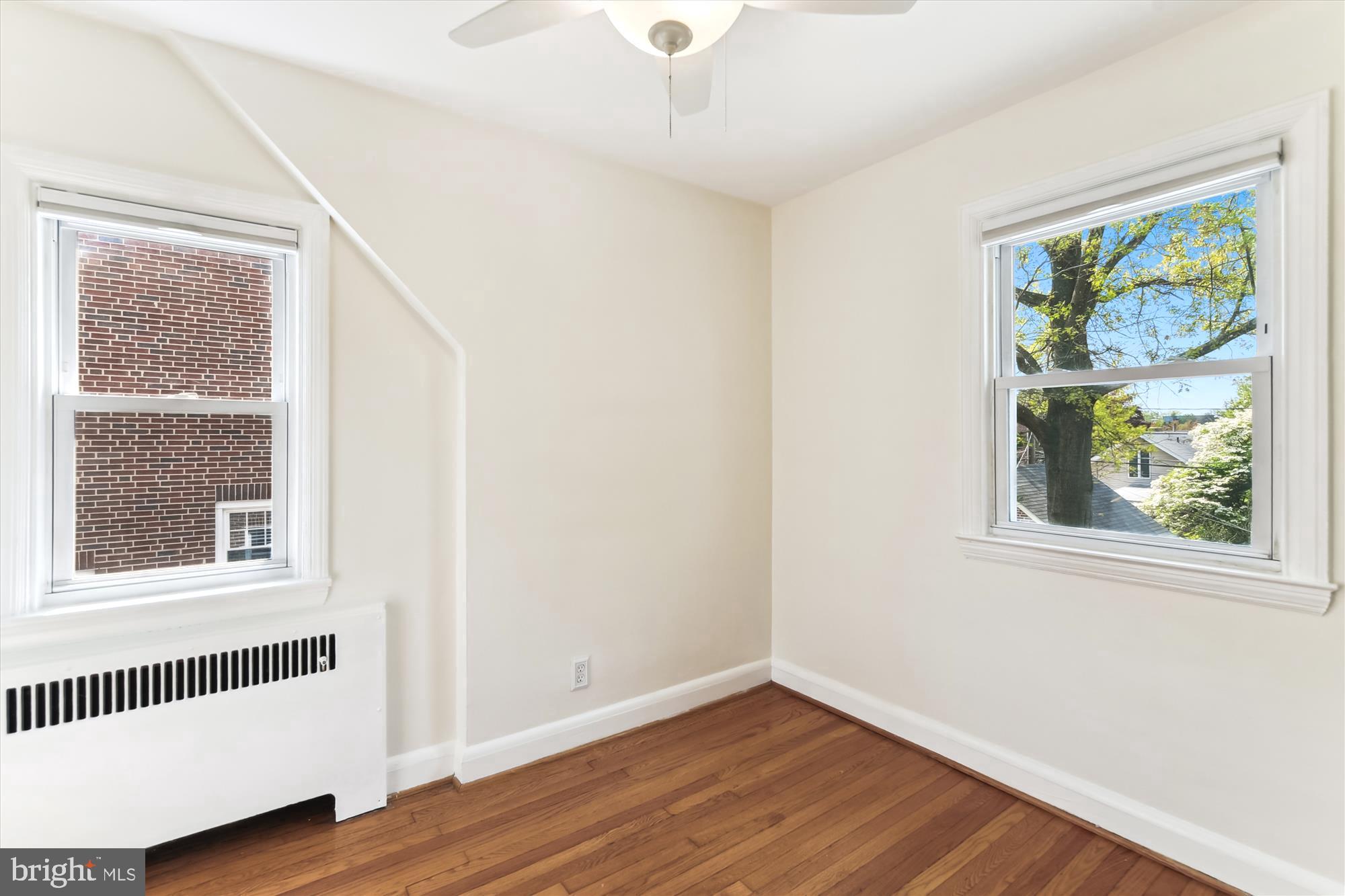 501 Dunkirk Road Baltimore, MD 21212 - Photo 21 of 38 an empty room with wooden floor windows and entrance