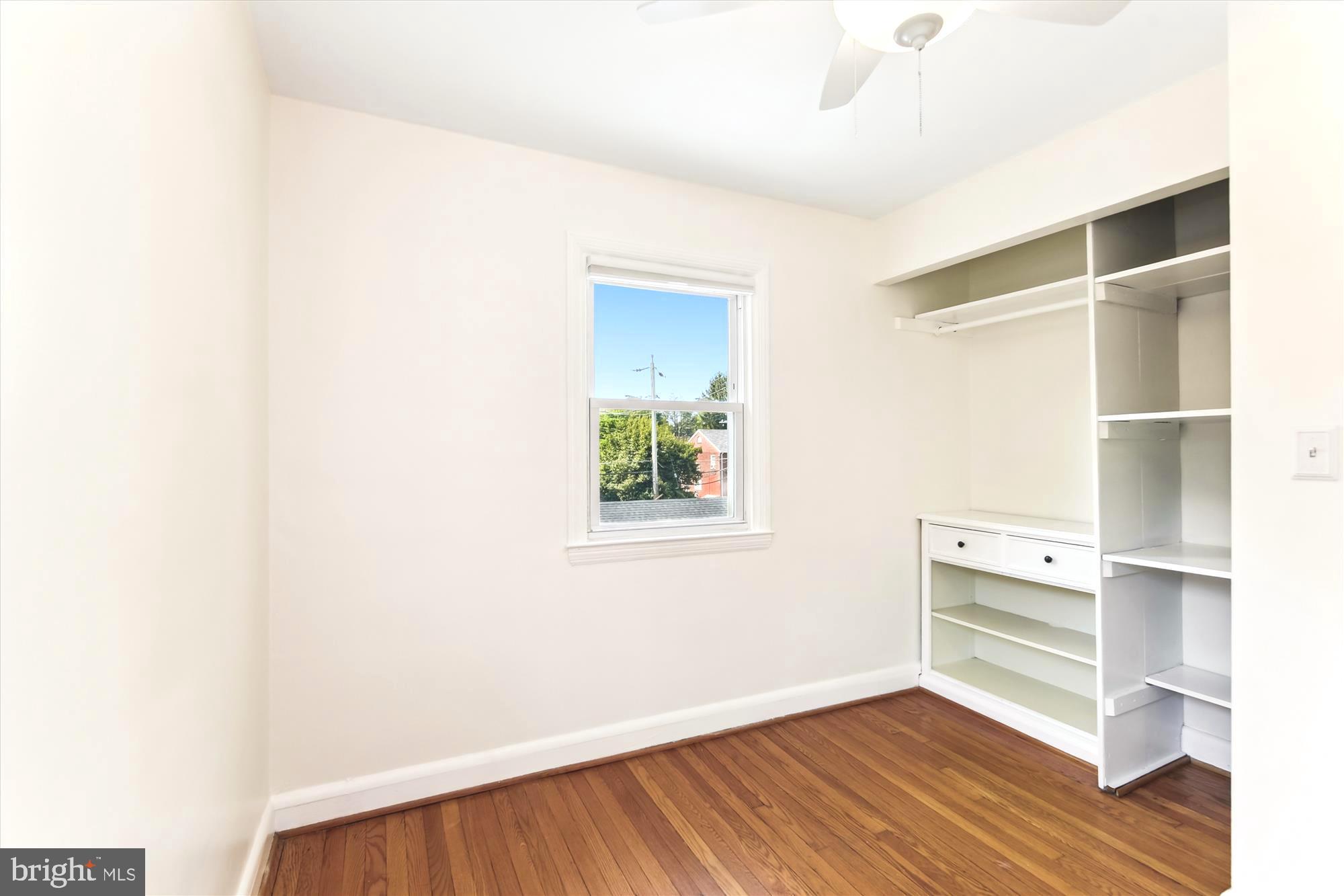 501 Dunkirk Road Baltimore, MD 21212 - Photo 22 of 38 a view of an empty room with wooden floor and a window