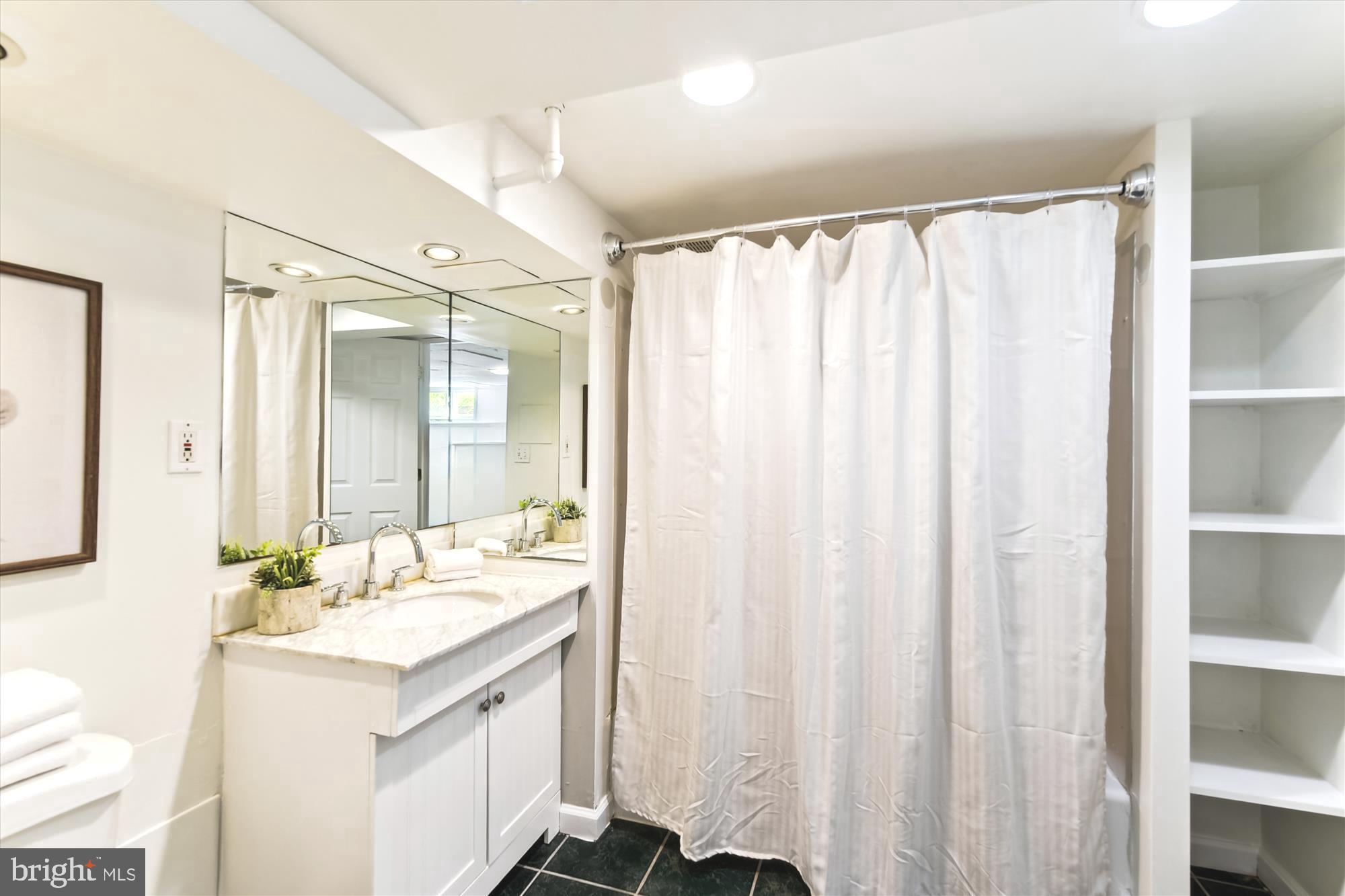 501 Dunkirk Road Baltimore, MD 21212 - Photo 25 of 38 a bathroom with a double vanity sink and a mirror