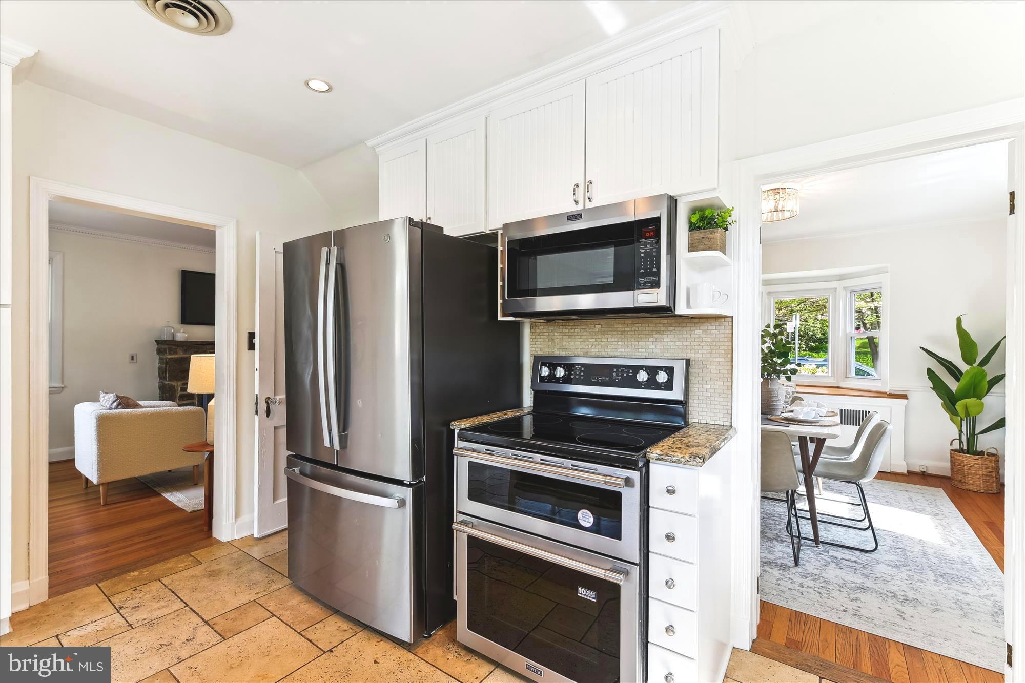 501 Dunkirk Road Baltimore, MD 21212 - Photo 10 of 38 a kitchen with a refrigerator microwave and stove top oven