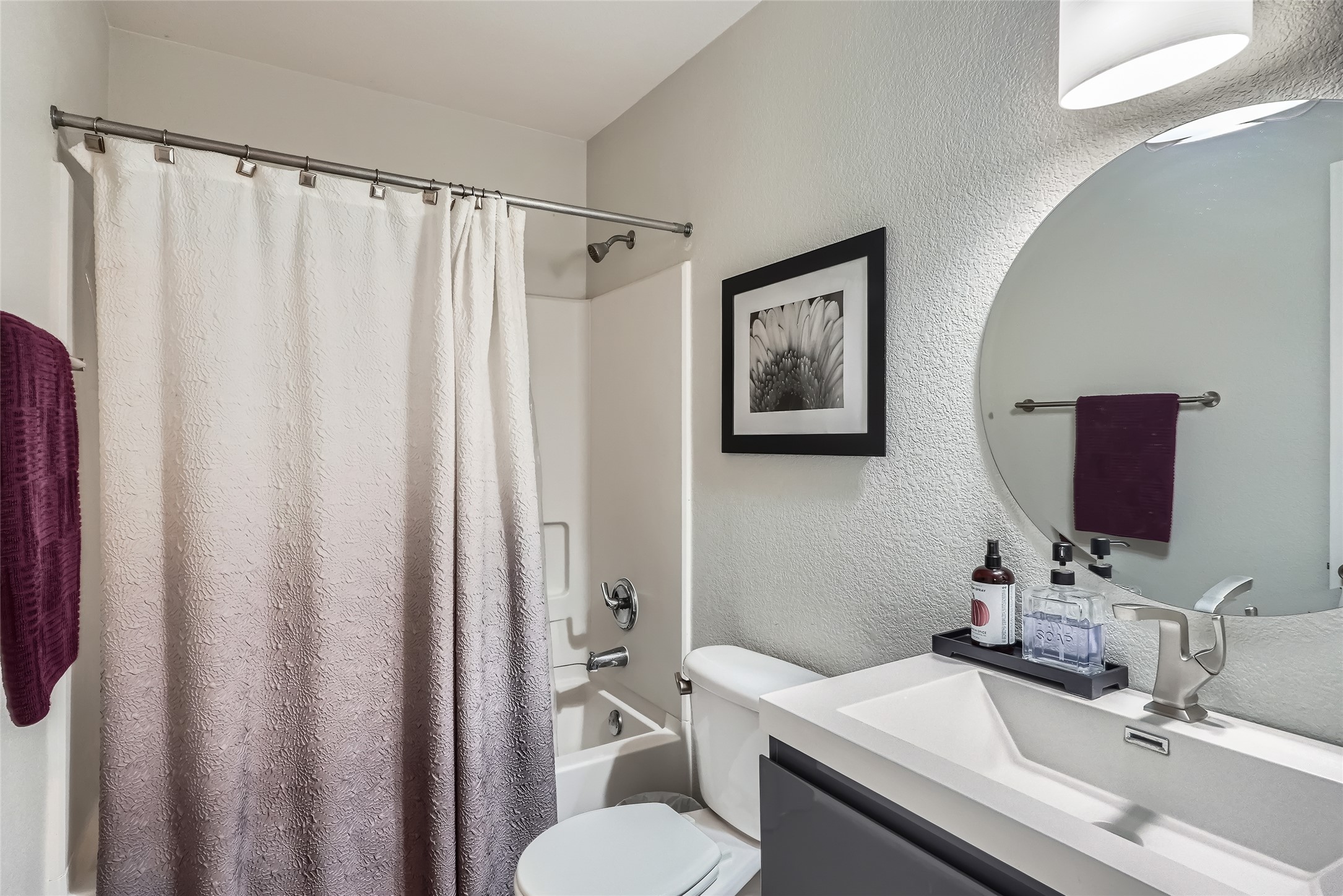 18021 Prairie Verbena Lane Elgin, TX 78621 - Photo 17 of 33 A well-lit bathroom features a full-sized tub and shower with a contemporary vanity.