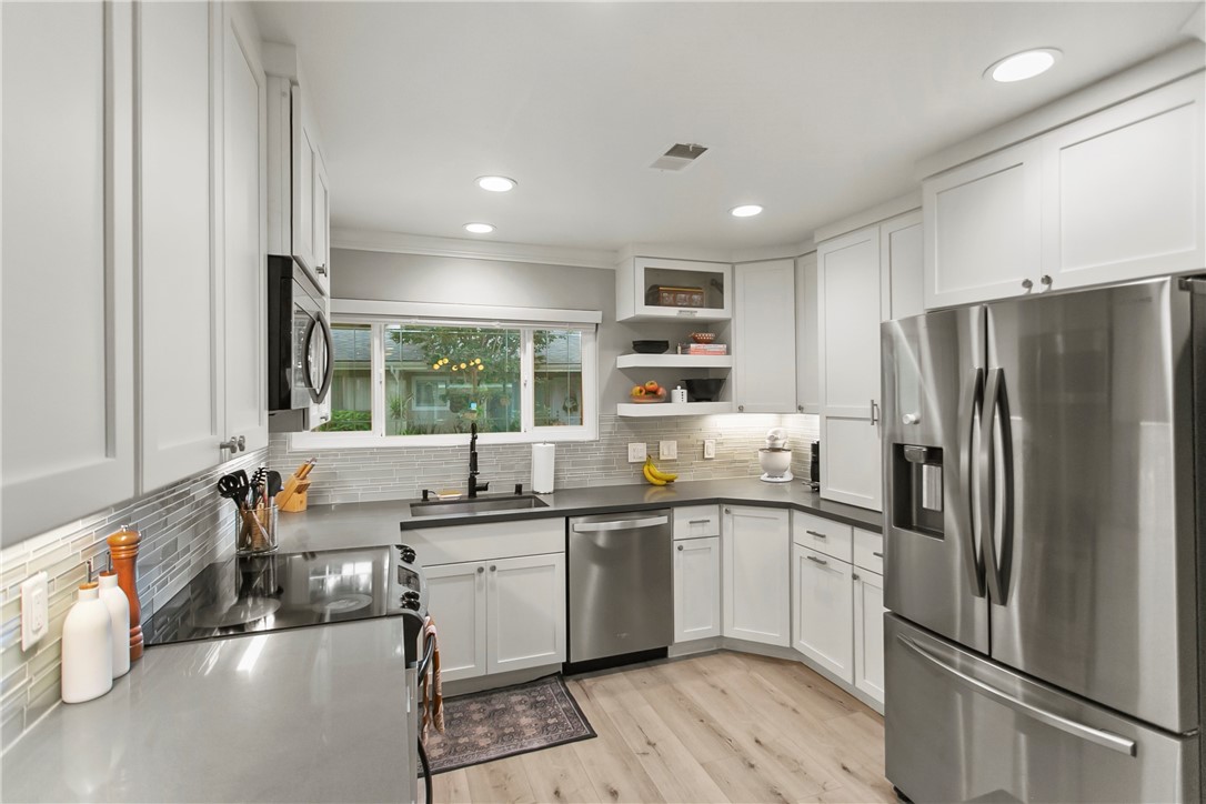1404 North Tustin Avenue, Unit E2 Santa Ana, CA 92705 - Photo 12 of 27 a kitchen with stainless steel appliances granite countertop a sink stove and refrigerator