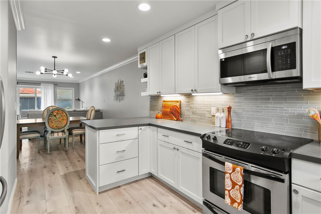 1404 North Tustin Avenue, Unit E2 Santa Ana, CA 92705 - Photo 13 of 27 a kitchen with stainless steel appliances a stove microwave and cabinets