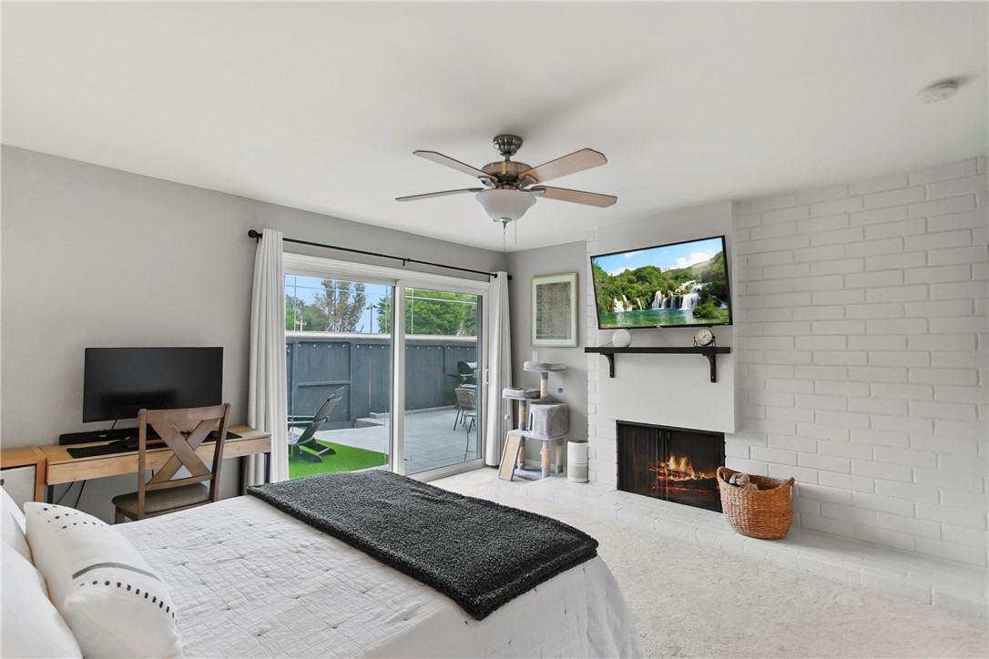 1404 North Tustin Avenue, Unit E2 Santa Ana, CA 92705 - Photo 15 of 27 a living room with furniture a fireplace and a flat screen tv