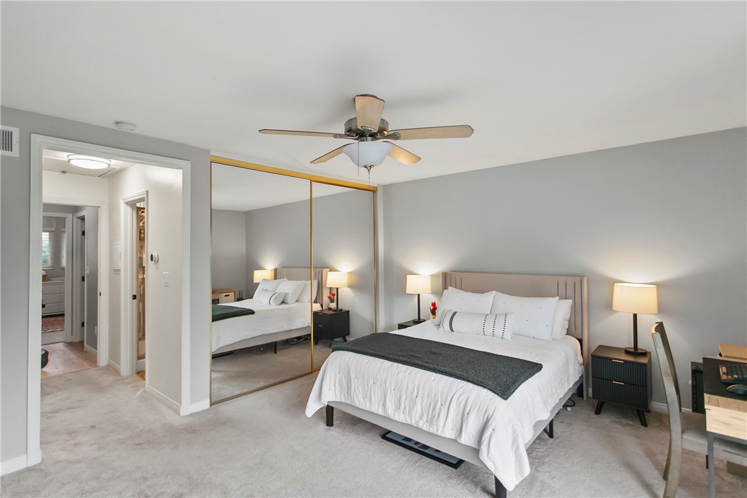 1404 North Tustin Avenue, Unit E2 Santa Ana, CA 92705 - Photo 16 of 27 a bedroom with a bed and ceiling fan