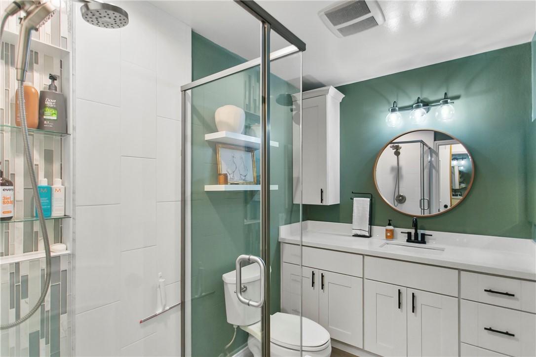 1404 North Tustin Avenue, Unit E2 Santa Ana, CA 92705 - Photo 17 of 27 a bathroom with a toilet a sink and mirror