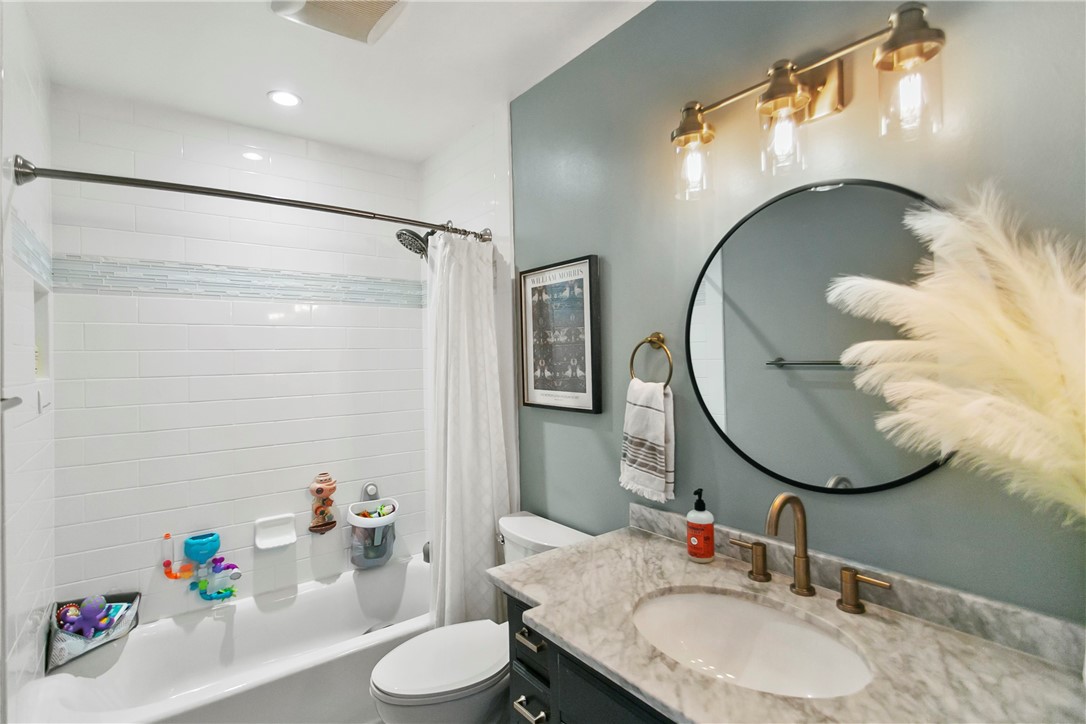 1404 North Tustin Avenue, Unit E2 Santa Ana, CA 92705 - Photo 18 of 27 a bathroom with a sink mirror and toilet