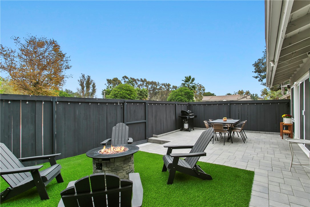1404 North Tustin Avenue, Unit E2 Santa Ana, CA 92705 - Photo 24 of 27 a view of a backyard with table and chairs potted plants and wooden fence
