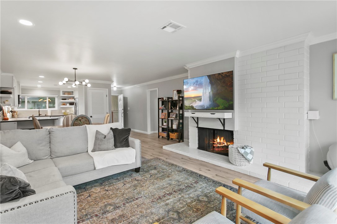 1404 North Tustin Avenue, Unit E2 Santa Ana, CA 92705 - Photo 9 of 27 a living room with furniture a fireplace and a flat screen tv