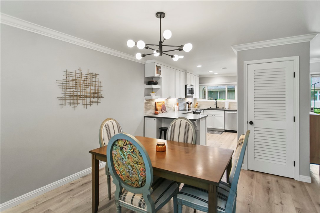 1404 North Tustin Avenue, Unit E2 Santa Ana, CA 92705 - Photo 10 of 27 a dining room with furniture a chandelier and wooden floor