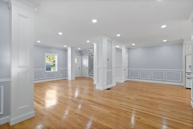a view of empty room with wooden floor