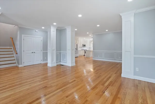 a view of empty room with wooden floor