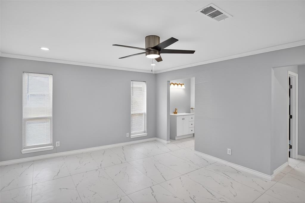 835 38th Street Southeast Paris, TX 75462 - Photo 11 of 25 a view of a livingroom with a ceiling fan window and a kitchen space