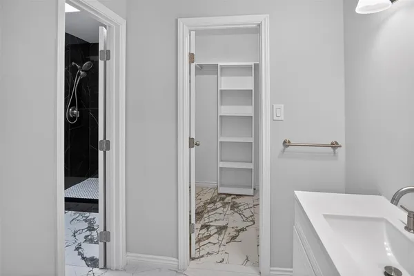 a bathroom with a glass shower door