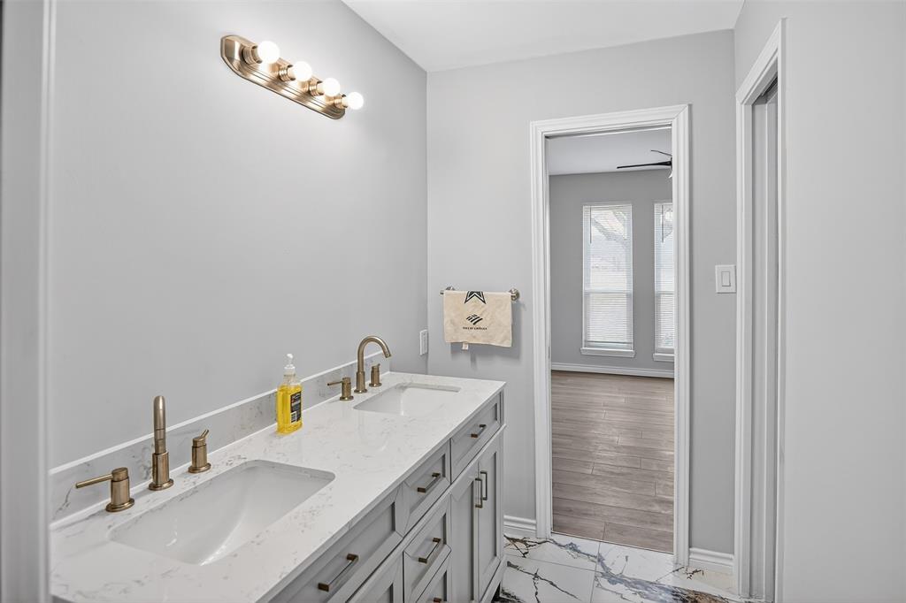 835 38th Street Southeast Paris, TX 75462 - Photo 17 of 25 a bathroom with a sink vanity and a mirror