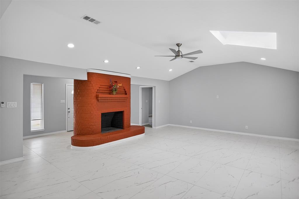 835 38th Street Southeast Paris, TX 75462 - Photo 3 of 25 an empty room with fireplace and fan