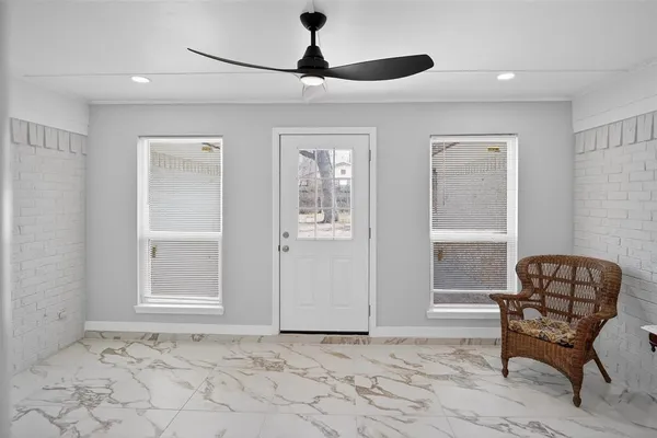 a large white kitchen with stainless steel appliances kitchen island granite countertop a sink and cabinets