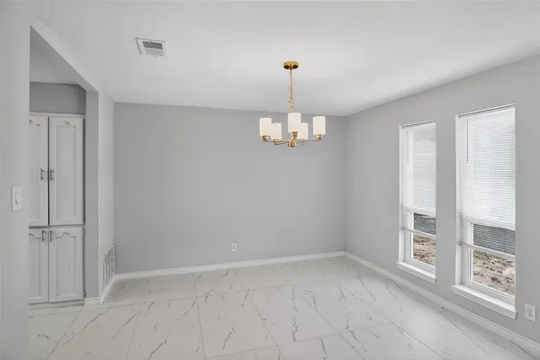 a view of a livingroom with a ceiling fan window and a kitchen space