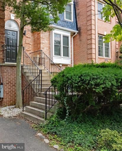 Charming brick entrance with greenery.