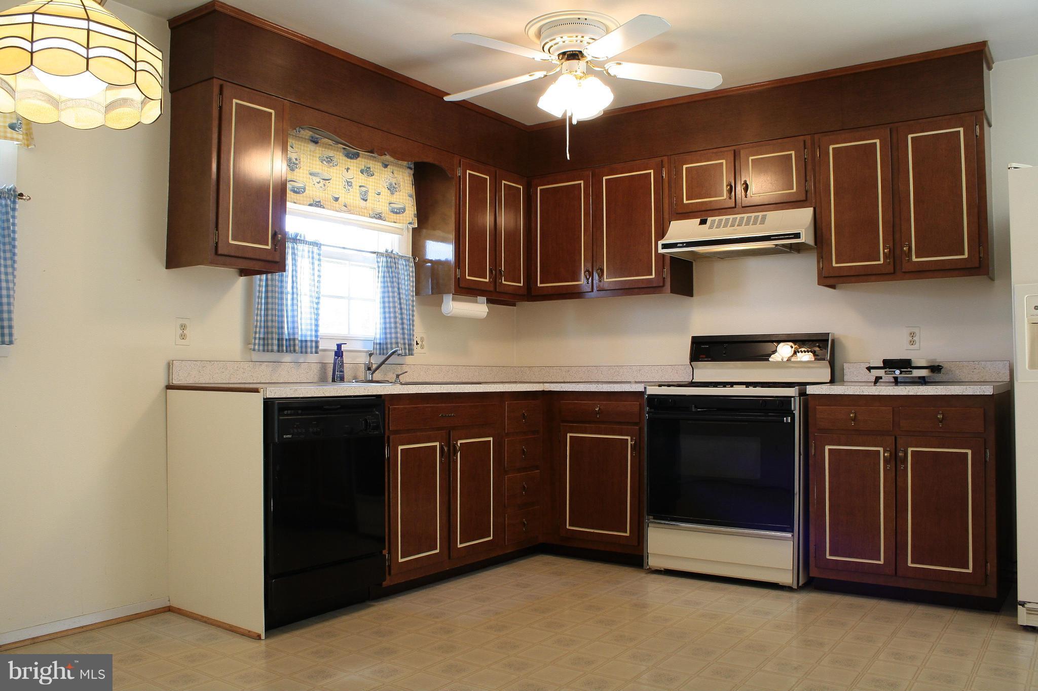 9008 Kilbride Road Baltimore, MD 21236 - Photo 10 of 30 a kitchen with stainless steel appliances granite countertop a sink stove and microwave