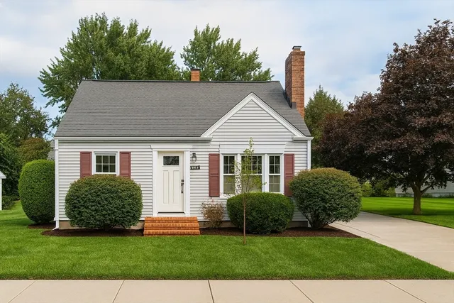 a front view of a house with a garden