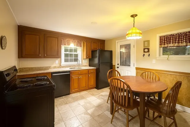 a kitchen with stainless steel appliances granite countertop a stove a sink a microwave and dining table