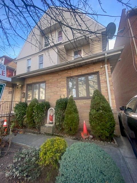 a front view of a brick house with a yard