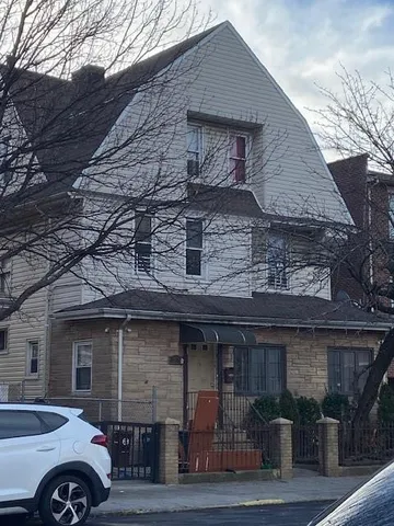 a front view of a house with parking area