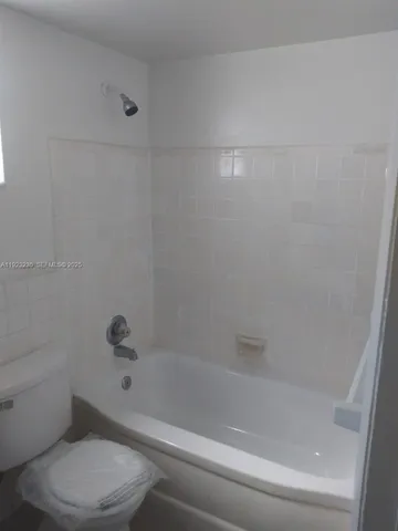 a bathroom with a toilet and a bathtub