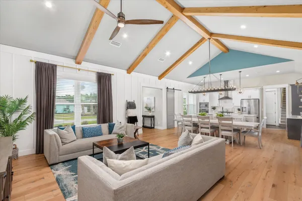a bedroom with a bed wooden floor and a table