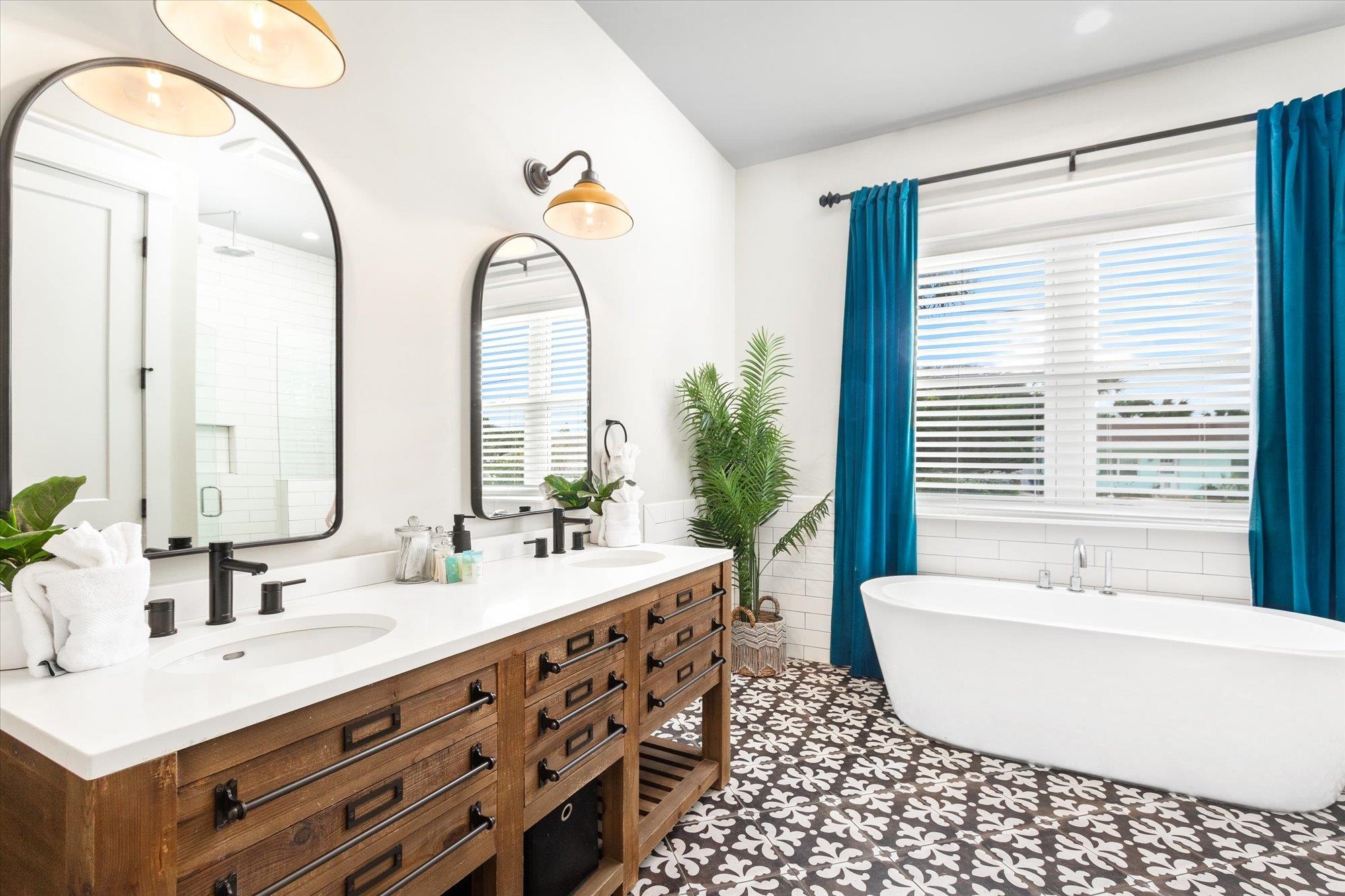 80 Ferrol Road St. Augustine, FL 32084 - Photo 22 of 61 a bathroom with a double vanity sink a mirror and a bathtub