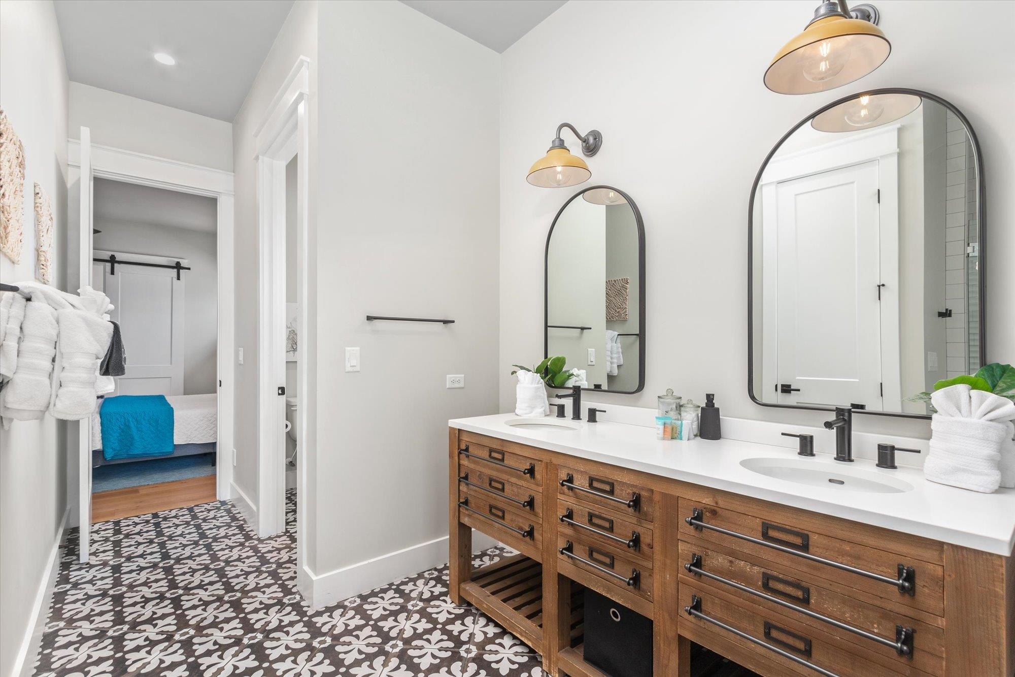 80 Ferrol Road St. Augustine, FL 32084 - Photo 25 of 61 a bathroom with a double vanity sink and a mirror
